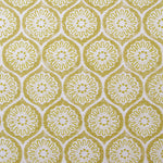 Detail of fabric in a floral lattice print in yellow on a cream field.
