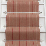 Striped flatweave runner in red and sand on white staircase