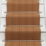 Striped flatweave runner in orange on white staircase