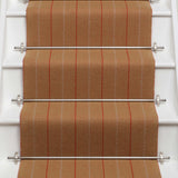Striped flatweave runner in orange on white staircase