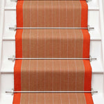 Striped flatweave runner in orange on white staircase