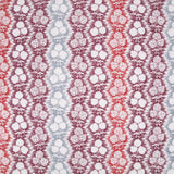 Fabric in a detailed botanical stripe print in shades of blue, red and purple on a white field.