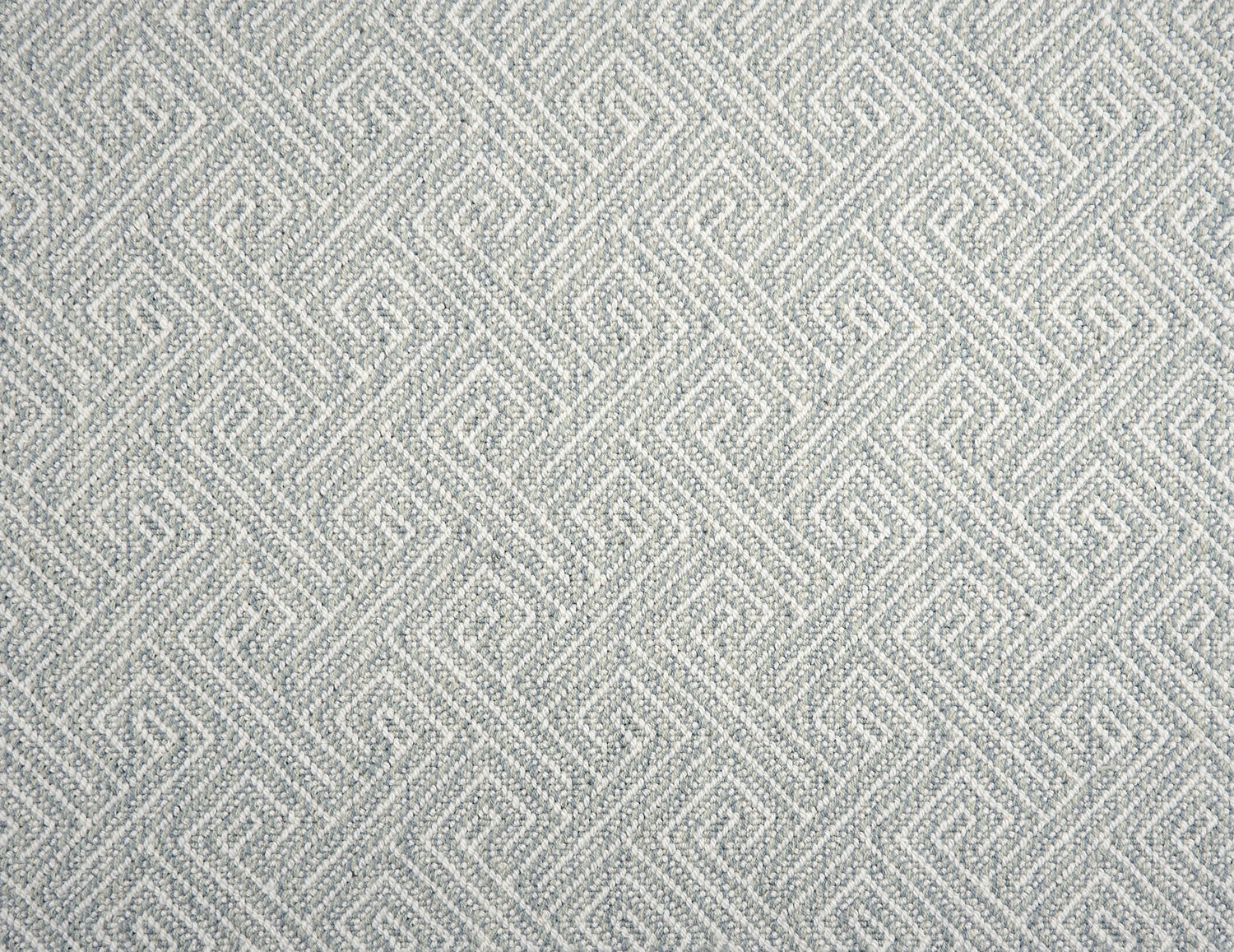 Broadloom carpet with Greek key pattern in cream on pale blue.