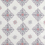 Scaled-out view of fabric in a diamond damask print in shades of pink, purple, blue and green on a cream field.