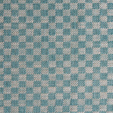 Close up of woven fabric with small scale checkerboard pattern in white and turquoise. 