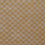 Close up of woven fabric with small scale checkerboard pattern in white and light orange.