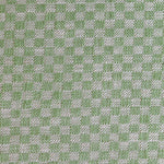 Close up of woven fabric with small scale checkerboard pattern in white and bright green. 