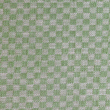 Close up of woven fabric with small scale checkerboard pattern in white and bright green. 