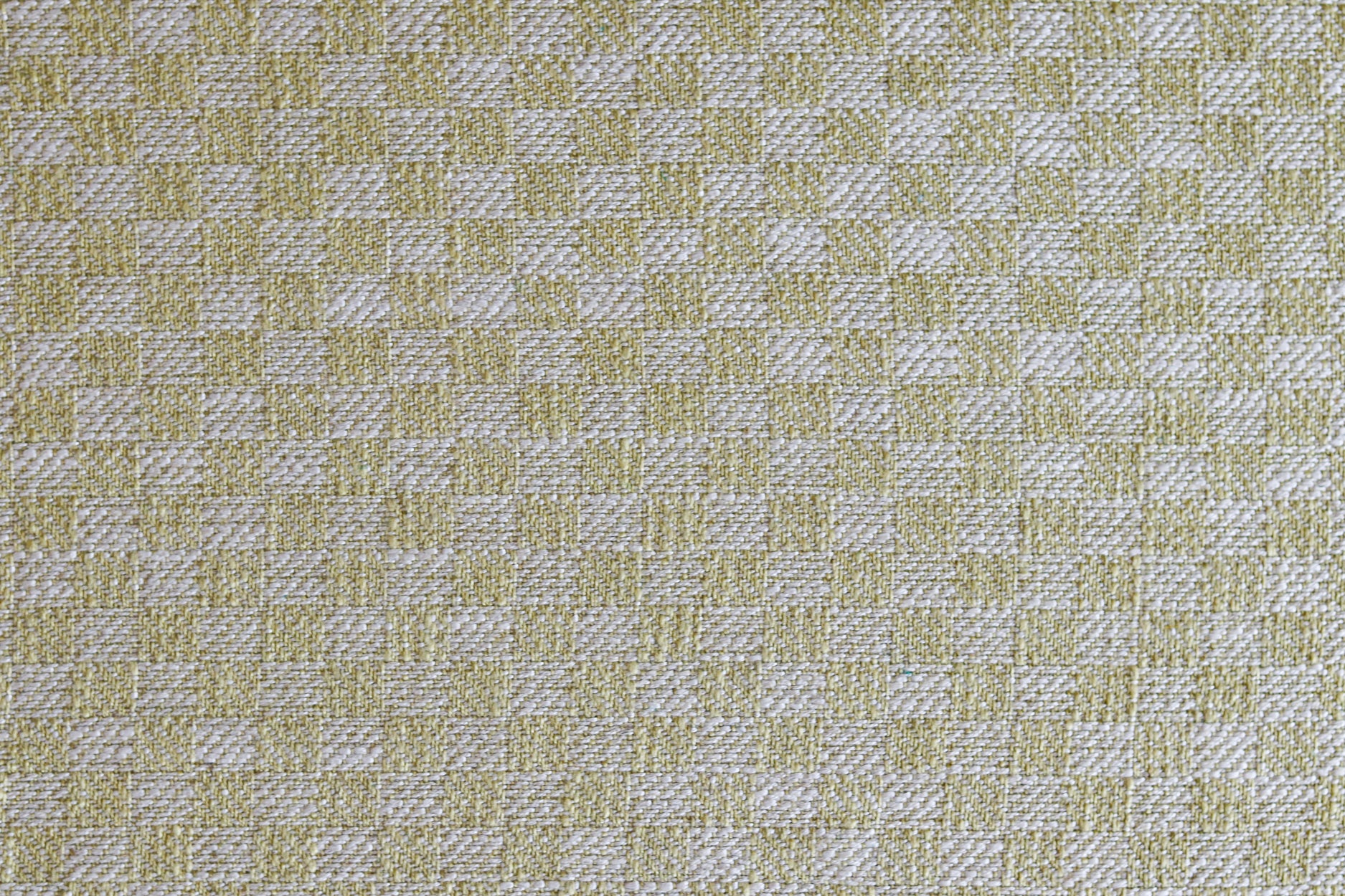 Close up of woven fabric with small scale checkerboard pattern in white and pale green. 