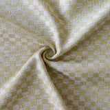 Close up of draped woven fabric with small scale checkerboard pattern in white and pale green. 