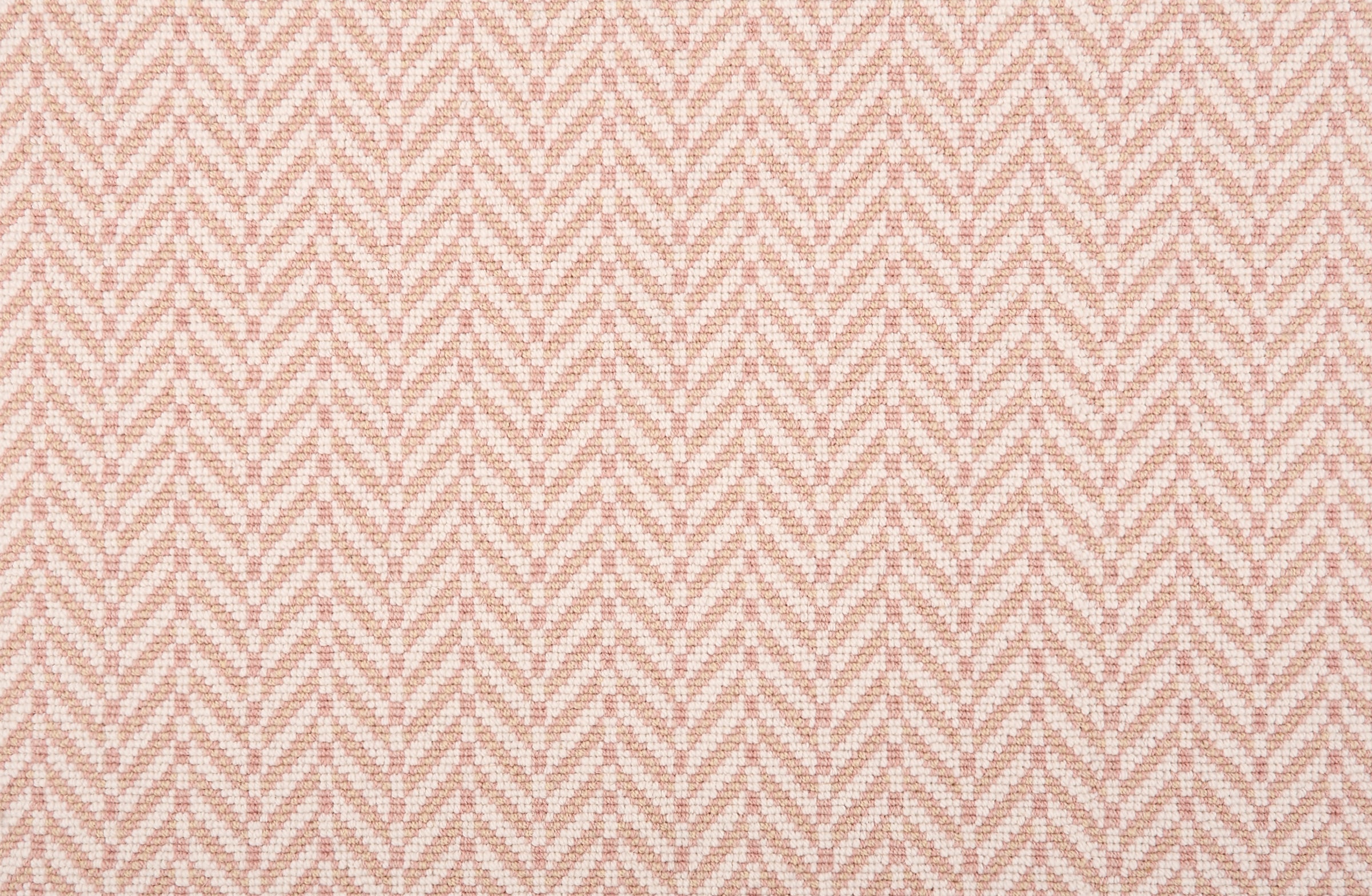 Broadloom carpet in a herringbone pattern pastel pink and white. 