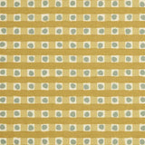 Detail of fabric in a playful dotted check print in gray and mustard on a cream field.