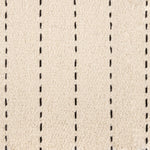 Broadloom carpet with a thin dashed stripe in black leather on a cream field.
