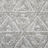 Broadloom carpet sample in a textural stacked triangle pattern in white and taupe.