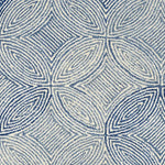 Broadloom carpet in a circular mosaic design in dense stripes of white and blue.