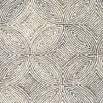 Broadloom carpet in a circular mosaic design in dense stripes of white and taupe.