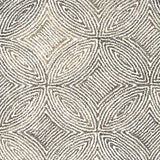 Broadloom carpet in a circular mosaic design in dense stripes of white and taupe.