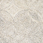 Broadloom carpet in a circular mosaic design in dense stripes of white and ecru.