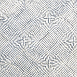 Broadloom carpet in a circular mosaic design in dense stripes of white and coll grey.