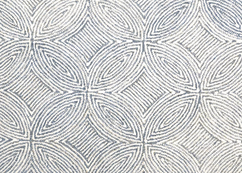 Broadloom carpet in a circular mosaic design in dense stripes of white and coll grey.