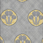 Detail of fabric in a repeating curvilinear floral print in yellow and gray on a gray field.