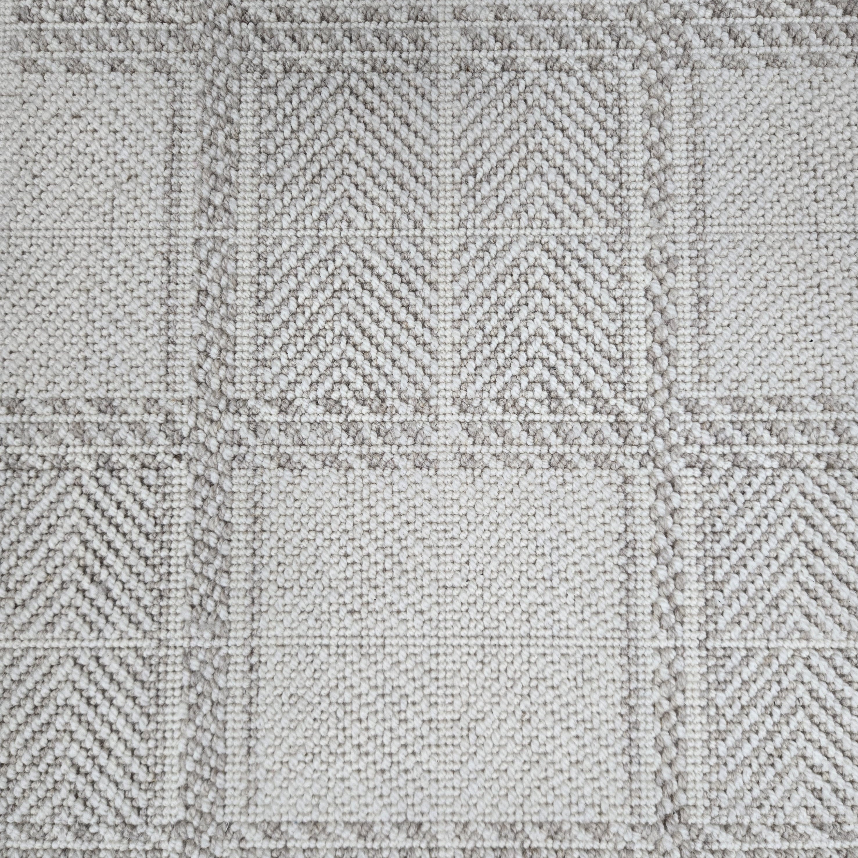 Broadloom carpet in wide box checkerboard pattern in cream and grey.