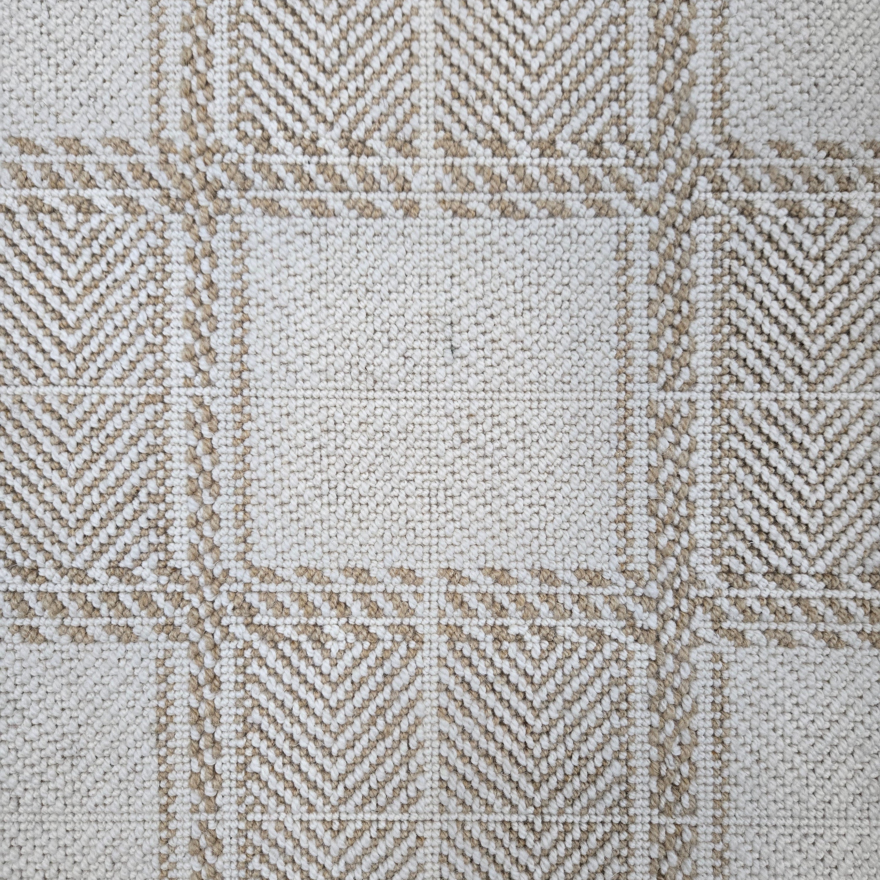 Broadloom carpet in wide box checkerboard pattern in cream and tan.