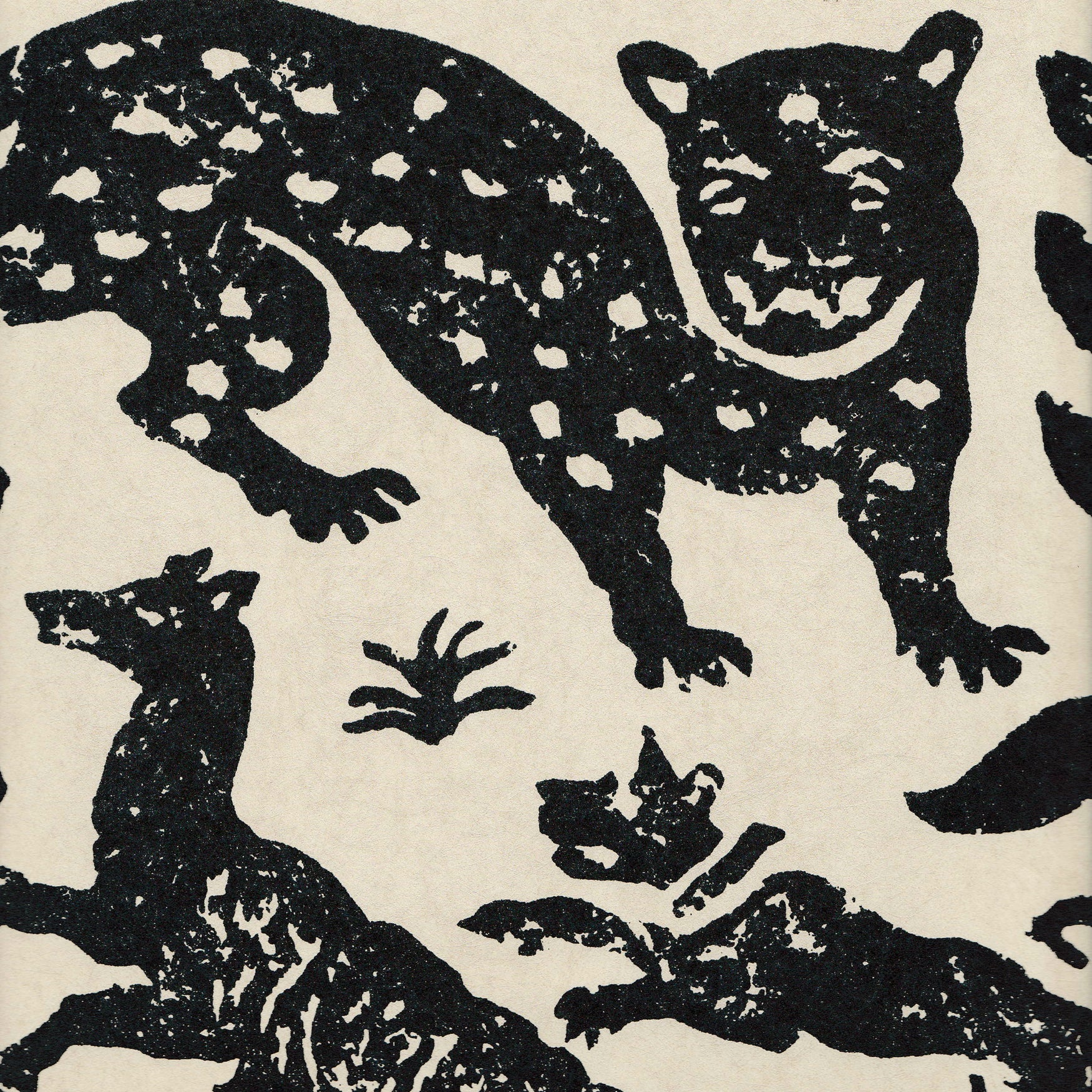 Detail of wallpaper in a playful animal print in black on a cream field.