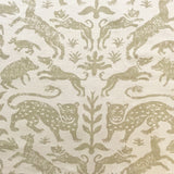 Detail of fabric in a playful animal print in tan on a cream field.