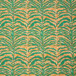 Detail of fabric in a linear botanical print in green on a mottled cream and orange field.