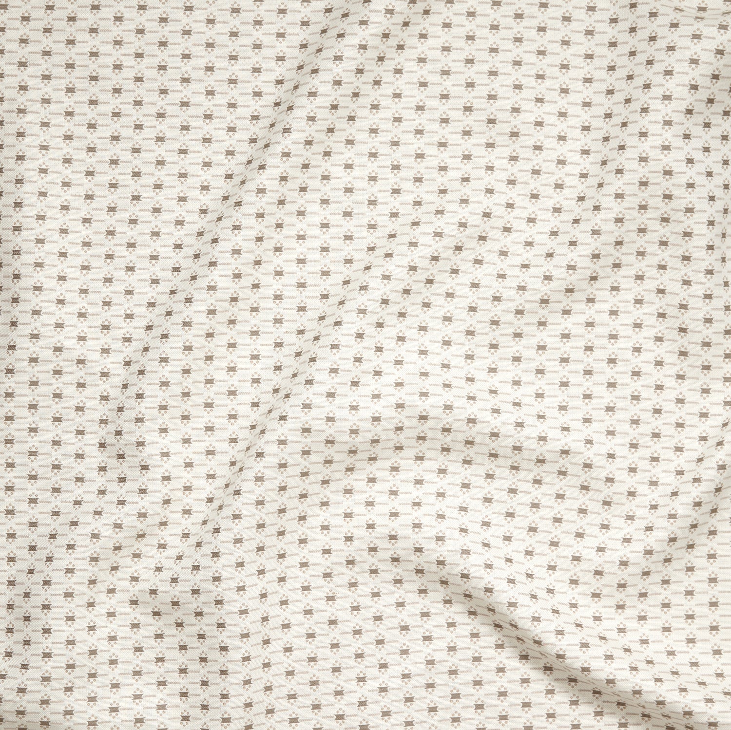 Close up of gently draped woven Indoor-Outdoor fabric with small scale geometric ditsy print in beige and taupe on ivory. 