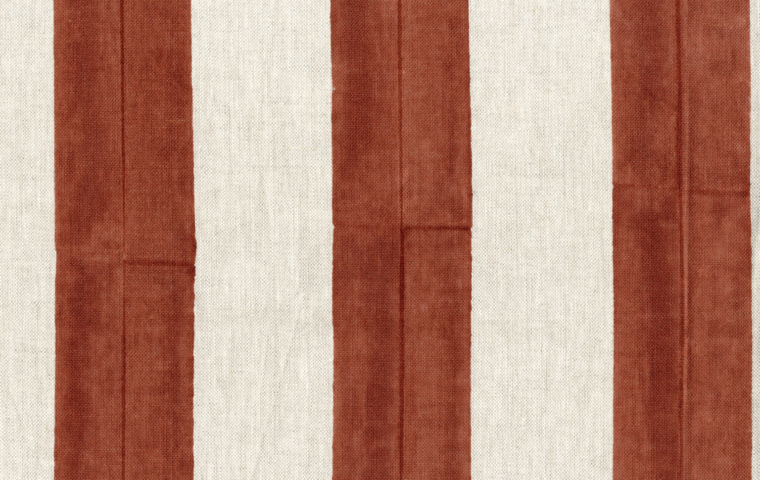 Fabric in a wide stripe pattern in rust and cream.