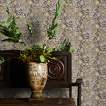 Decorative wallpaper with brown floral pattern, wooden cabinet with plants, and ornate vase.