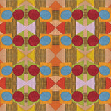 Close up of printed wallpaper with a complex geometric pattern with red, blue, orange and green. 