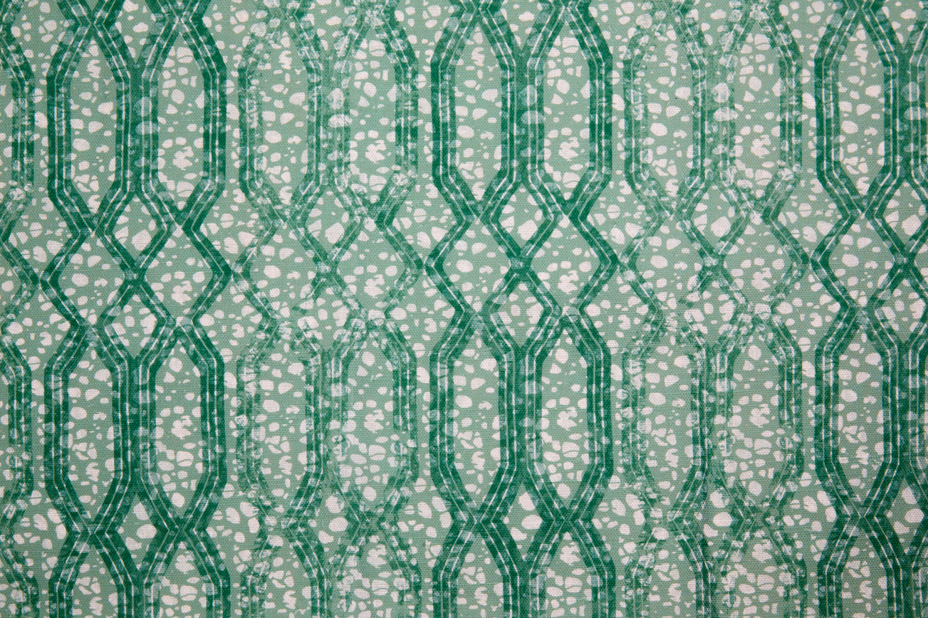 Printed fabric with monochomatic geometric stripe and mottled textural background in shades of green.