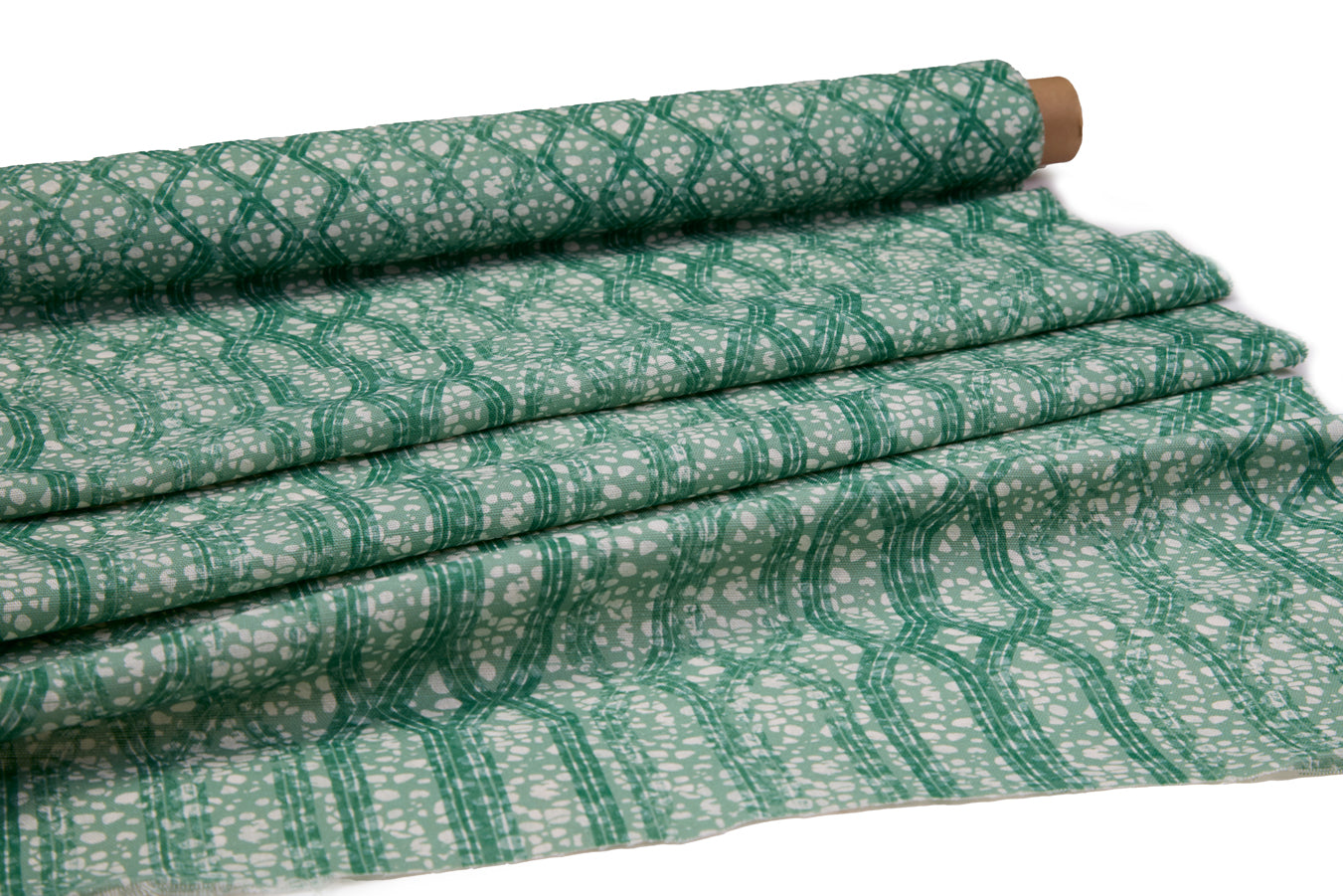 Draped fabric coming off a roll with monochomatic geometric stripe and mottled textural background in shades of green.