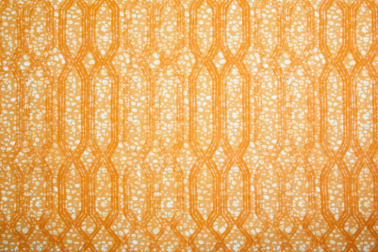 Printed fabric with monochomatic geometric stripe and mottled textural background in shades of orange. 