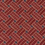 Detail of an embroidered fabric in a dashed basketweave design in red with blue accents.