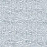 Detail of fabric in a textural geometric print in shades of light blue.