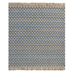Handwoven wool rug with textural oval pattern in blue on a beige field and fringe at top and bottom.
