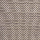 Handwoven wool rug with textural oval pattern in grey on a beige field. 