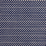 Handwoven wool rug with textural oval pattern in dark blue on a beige field. 