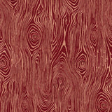 Detail of fabric in a textural wood grain print in coral on a red field.