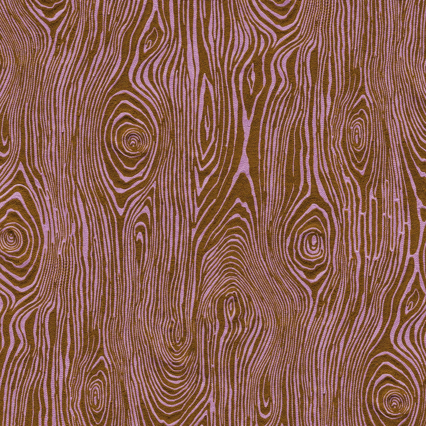 Detail of fabric in a textural wood grain print in purple on a brown field.