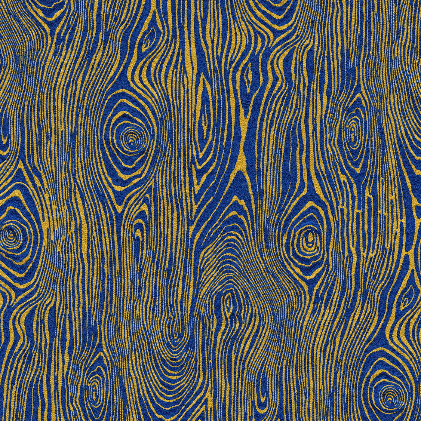 Detail of wallpaper in a textural wood grain print in yellow on a blue field.