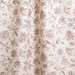 Draped fabric in a watercolor floral pattern with wine-purple leaves and flowers on a cream background