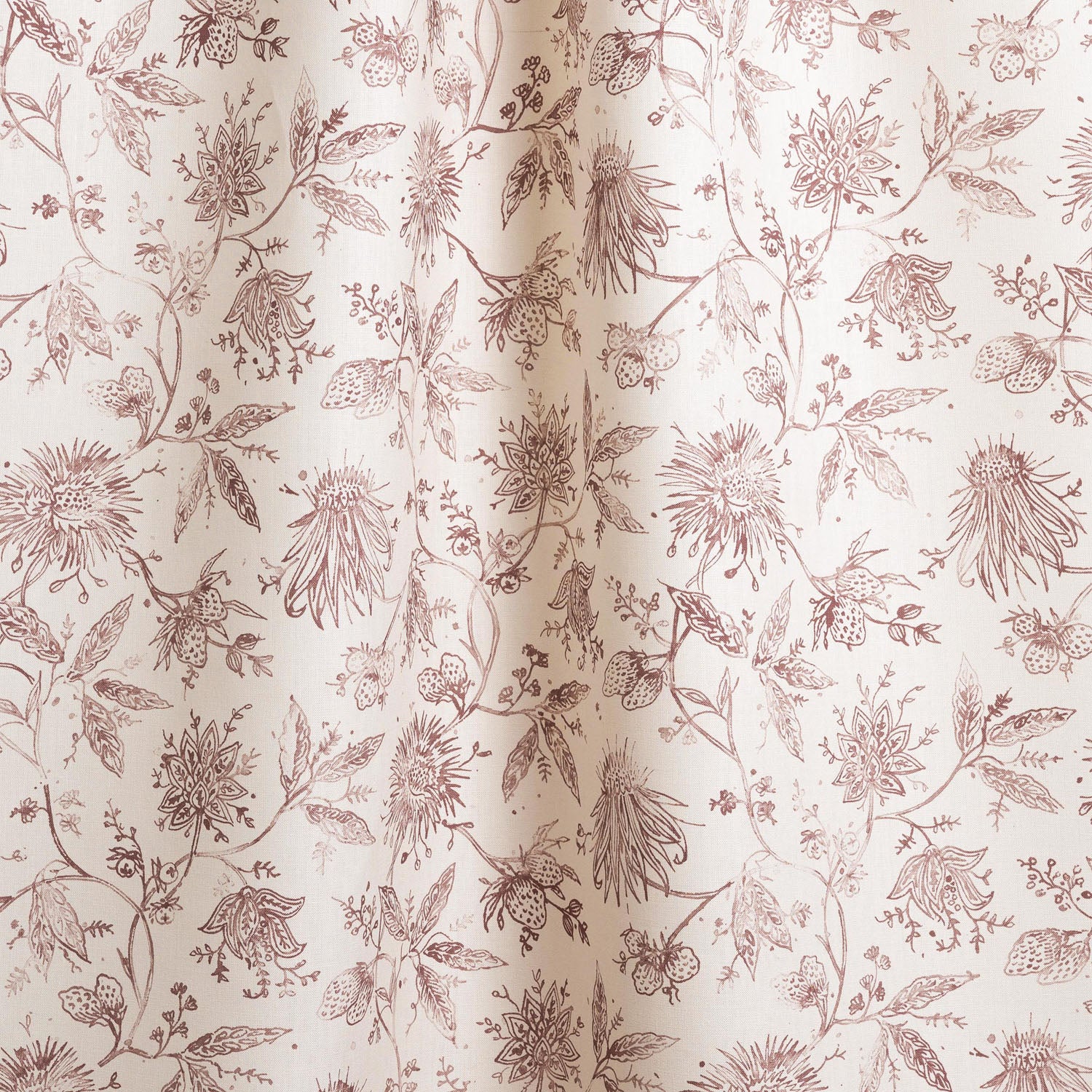 Draped fabric in a watercolor floral pattern with wine-purple leaves and flowers on a cream background