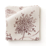 Fabric swatc with watercolor floral pattern with wine-purple leaves and flowers on a cream background