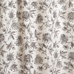 Draped fabric with watercolor floral pattern with black leaves and flowers on a cream background