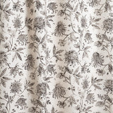 Draped fabric with watercolor floral pattern with black leaves and flowers on a cream background